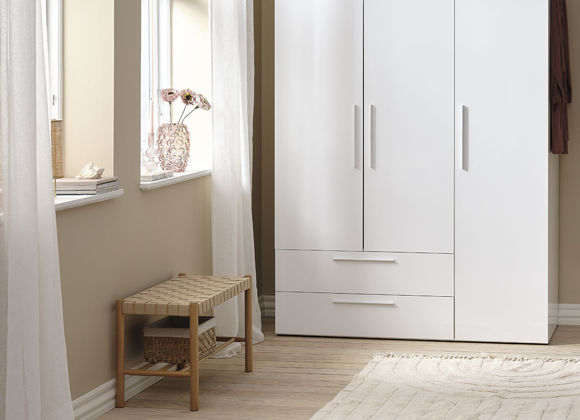 Bench in a guestroom with large wardrobe