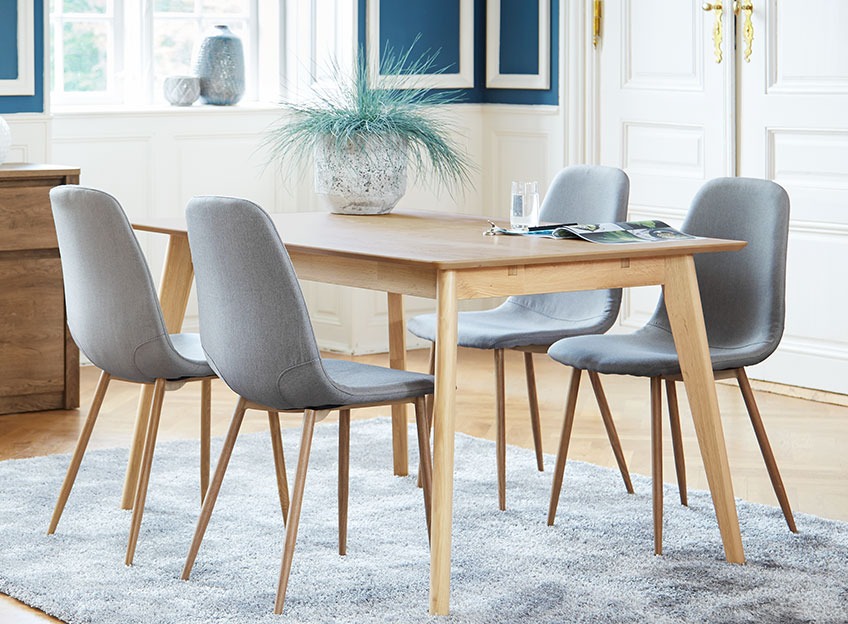 Oak dining table and grey dining chairs in a classy dining room