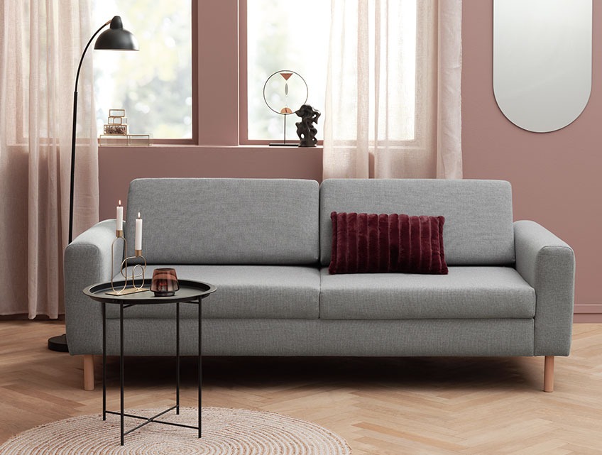 Living room with a grey fabric sofa with room for 3 people in a modern living room