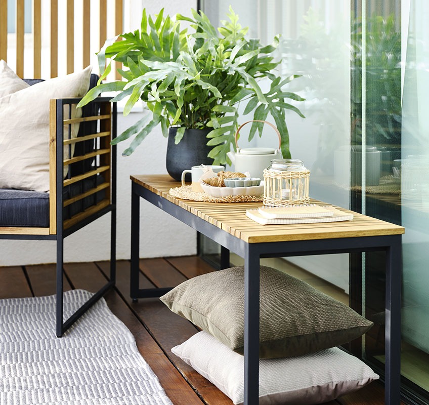 Balcony decorated with lounge chair and garden bench 