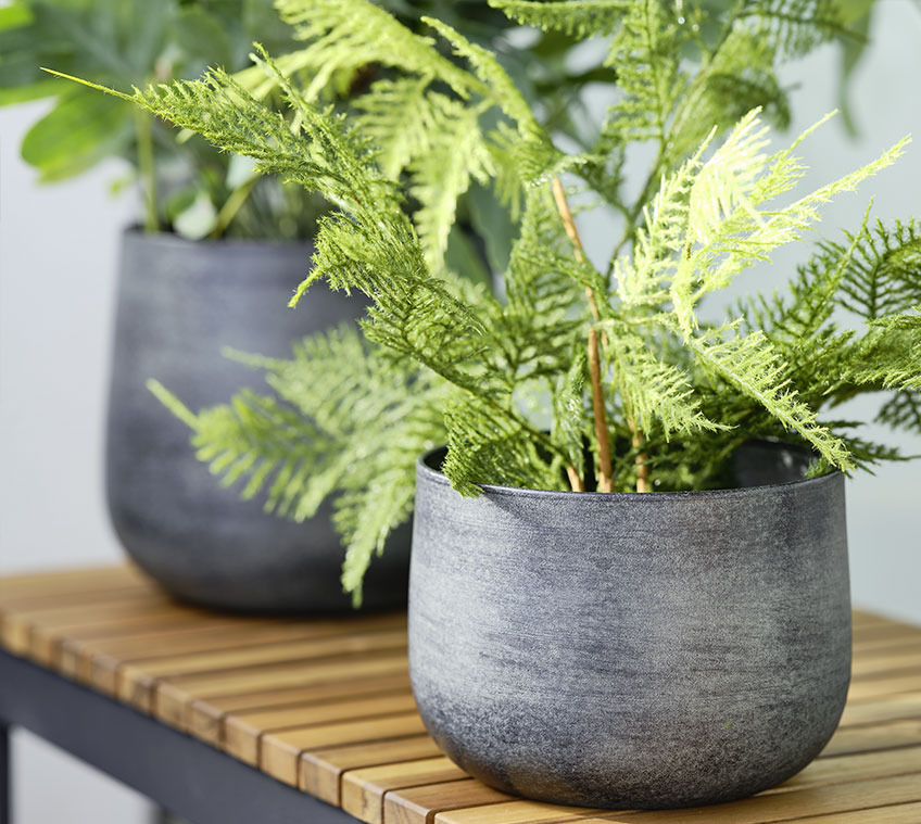 RUSTAND garden planter is available in different sizes and colours Garden bench with a fern in a metal garden planter