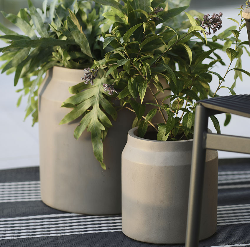 Two grey garden planters on a rug