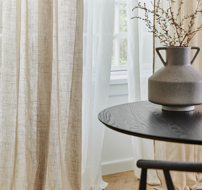 Khaki and white sheer curtain in front of window