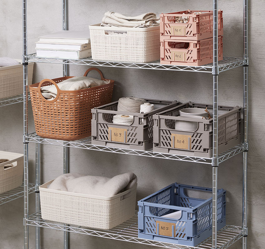 MILAS basket is available in blue, grey and coral Blue, grey and coral plastic baskets on a shelving unit