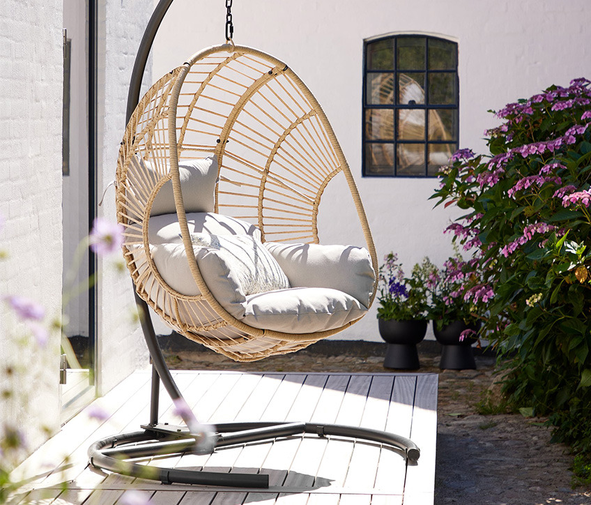 GJERN hanging chair Hanging chair in natural colour on patio