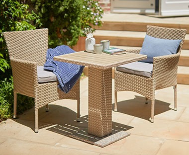 Rattan cafebord og stabelstole i natur på terrasse  